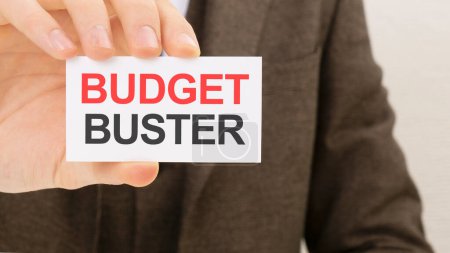 businessman holding a card with text BUDGET BUSTER.