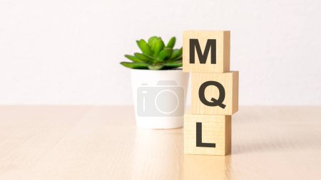 MQL - text on wooden cubes on wooden background. business concept.