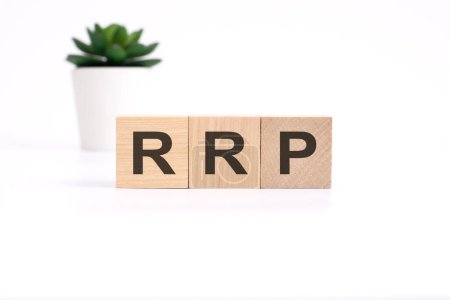 text RRP on wooden cubes on white background