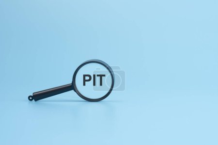 PIT text on magnifier on blue background, business concept