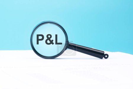 P and L text on magnifier on blue and white background, business concept
