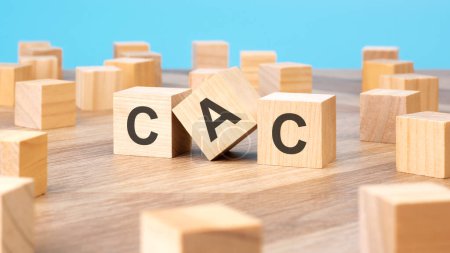 CAC written on wooden blocks, business concept, blue background