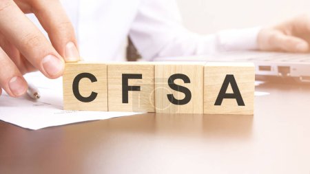 word CFSA made with wood building blocks, stock image. background may have blur effect