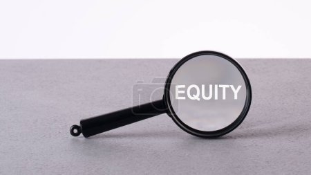 EQUITY text through a magnifying glass written on a light background.