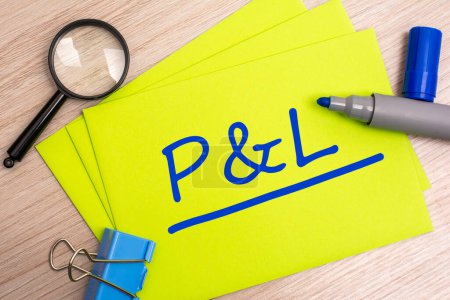 P and L - profit and loss - acronym text concept with blue marker on yellow card