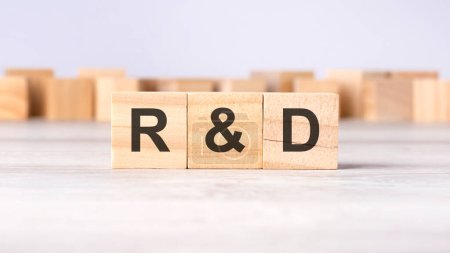 RD - acronym concept written on wooden cubes or blocks on a light grey background