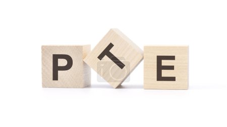 three wooden cubes with the letters pte on white background. Pearson Tests of English concept
