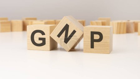 text GNP written on a wooden cubes. can be used for business, marketing, financial concept