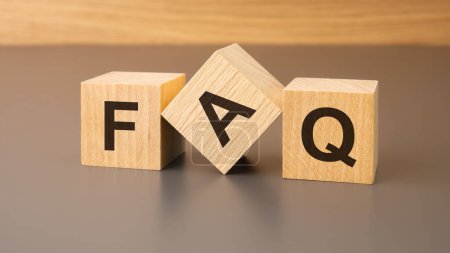 Photo for Wooden cubes on a brown background with the text FAQ - an abbreviation for Frequency Asked Questions. strong business concept - Royalty Free Image