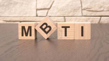 word MBTI cube wood on wooden table background. business concept