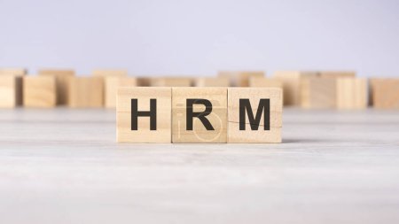 text HRM with wood cubes on gray background