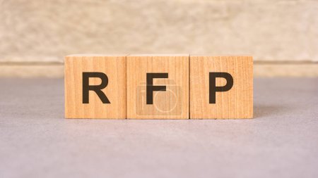 wooden block labeled RFP (Request For Proposal), symbolizes a formal invitation issued by a company to potential suppliers to submit proposals for a specific project or business opportunity.