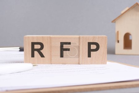 Photo for Rfp text made of wooden cubes on gray background with a small wooden model house - Royalty Free Image