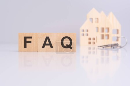 Holzwürfel mit Botschaft FAQ und kleine Modelle hölzerne Heimat. Fragen und Antworten zu Wohnungsproblemen. Geschäftskonzept