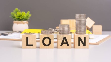 Photo for Concept conveyed by the image of wooden blocks spelling 'LOAN' with a stack of coins above symbolizes financial transactions, borrowing, and lending activities - Royalty Free Image