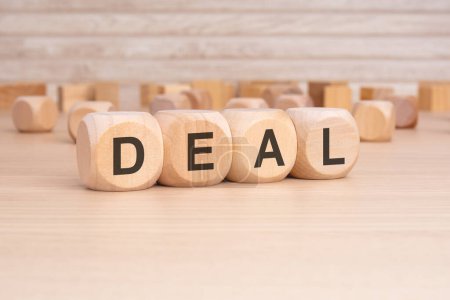 acronym DEAL on a wooden cubes with wooden background. copy space concept. selection focus