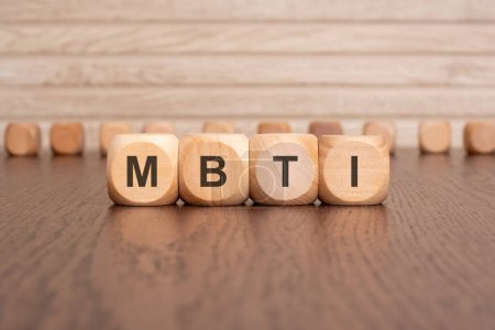 The text MBTI is written on wooden blocks on a light background.