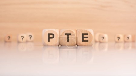 Wooden blocks with letters spelling PTE symbolize educational tools focused on language proficiency and exam preparation.