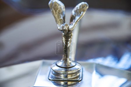 Photo for Rolls Royce 1977 hood ornament, retro car exhibition, Romania, Iasi 2020. Bonnet mascot Rolls Royce 1977. close up and selective focus on a hood. motor mascot or car mascot of a person with wings on classic vintage car - Royalty Free Image