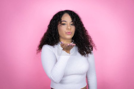 Photo for African american woman wearing casual sweater over pink background making fun of people with fingers on forehead doing loser gesture mocking and insulting. - Royalty Free Image