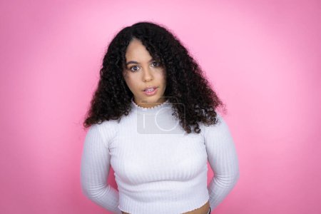 Photo for African american woman wearing casual sweater over pink background afraid and shocked with surprise and amazed expression, fear and excited face. - Royalty Free Image