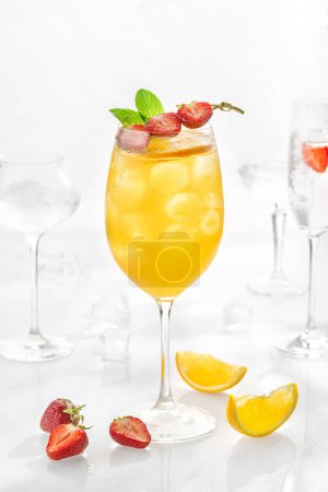Foto de Classic lemonade mix in glass on white background with passion fruit puree, melon, soda, orange. - Imagen libre de derechos