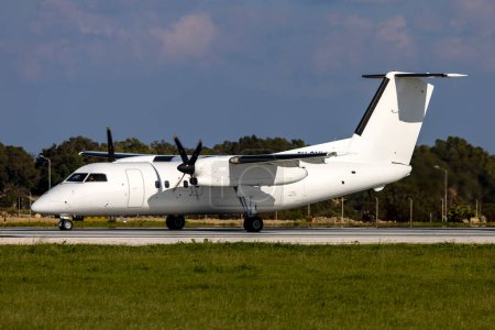 Photo for Luqa, Malta - February 12, 2023: Universal Air De Havilland Canada Dash 8-102 (Reg: 9H-ONI) turning on the Alpha loop for take off. - Royalty Free Image