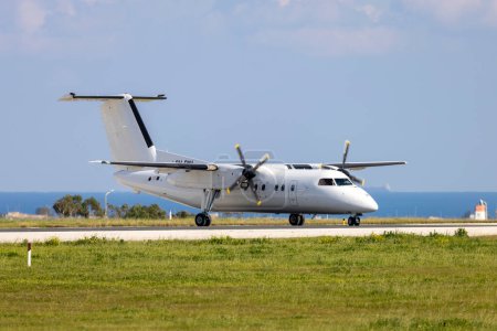 Photo for Luqa, Malta - February 12, 2023: Universal Air De Havilland Canada Dash 8-102 (Reg: 9H-ONI) turning on the Alpha loop for take off. - Royalty Free Image