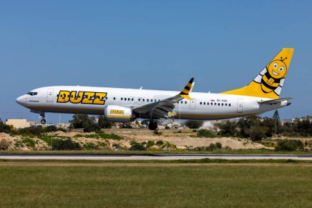 Photo for Luqa, Malta - March 26, 2023: Buzz (Ryanair) Boeing 737-8 MAX 200 (Reg.: SP-RZE) landing runway 31 on a sunny spring afternoon. - Royalty Free Image