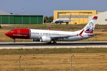 Photo for Luqa, Malta - June 30, 2023: Norwegian Air Sweden Boeing 737-8 MAX (REG: SE-RTE) departing runway 13. This plane is painted in honor of Norwegian artist Edvard Munch. - Royalty Free Image