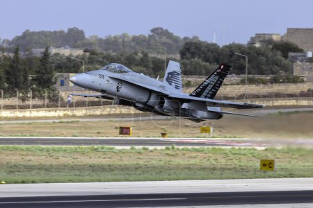 Photo for Luqa, Malta - September 23, 2023: Switzerland Air Force McDonnell Douglas FA-18C Hornet (REG: J-5018) taking off for display over St. Paul's Bay. - Royalty Free Image