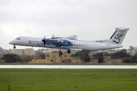 Foto de Luqa, Malta - 6 de enero de 2024: Nuevos aviones para Universal Air, un bombardero DHC-8-402 Q400 (Reg. : 9H-SWW). - Imagen libre de derechos