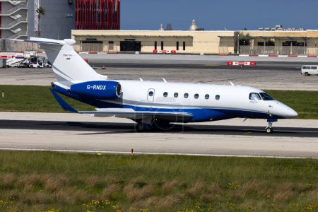 Photo for Luqa, Malta - March 18, 2024: Private Embraer EMB-550 Praetor 600 (REG: G-RNDX) taking off from mid length of the runway. - Royalty Free Image