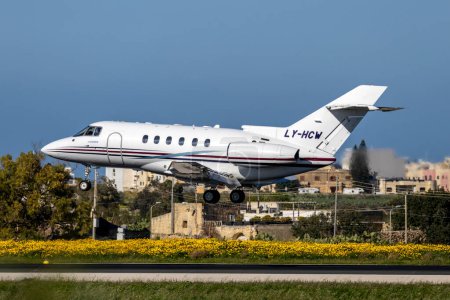 Photo for Luqa, Malta - March 6, 2024: Charter Jets Raytheon Hawker 800XP (REG: LY-HCW) on finals runway 31 in the afternoon. - Royalty Free Image