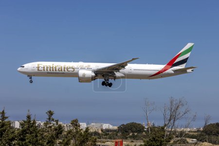 Photo for Luqa, Malta - April 6, 2024: Emirates Boeing 777-31H-ER (REG: A6-EPH) on finals runway 31. - Royalty Free Image