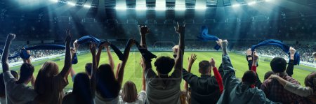 Support. Back view of football, soccer fans cheering their team with colorful scarfs at crowded stadium at evening. Concept of sport, cup, world, team, event, competition. Horizontal poster, flyer