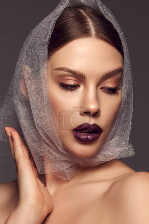 Photo for Modesty. Close-up portrait of glamorous female fashion model with artistic makeup expressing emotions over grey background. Style, beauty, high fashion, magazine style and ad - Royalty Free Image