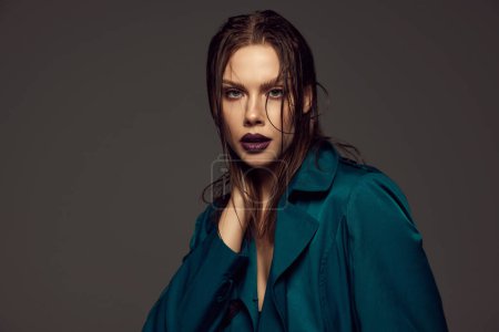 Photo for Serious young beautiful girl with artistic makeup looking at camera with challenge isolated over grey background. Attractive woman with purple lipstick. Style, beauty, high fashion, magazine style, ad - Royalty Free Image