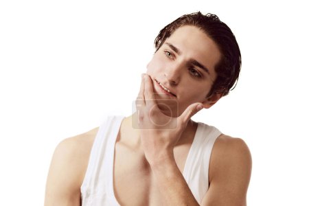 Photo for Portrait of young man after face shaving isolated over white background. Face cosmetics. Concept of male beauty, skincare, wellness, cosmetology, spa, body care. Copy space for ad - Royalty Free Image