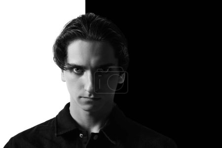 Photo for Black and white portrait of young man in classical shirt posing. Seriously looking at camera. Businessman look. Concept of mens fashion, style, business, emotions, skincare, lifestyle - Royalty Free Image