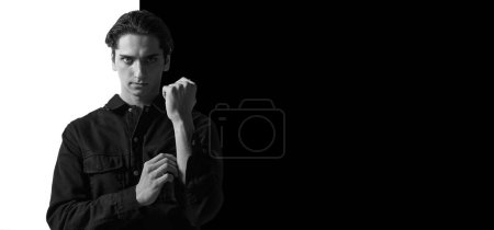 Photo for Black and white portrait of young man in casual jeans black shirt posing. Serious person. Concept of mens fashion, style, business, emotions, skincare, lifestyle. Copy space for ad - Royalty Free Image