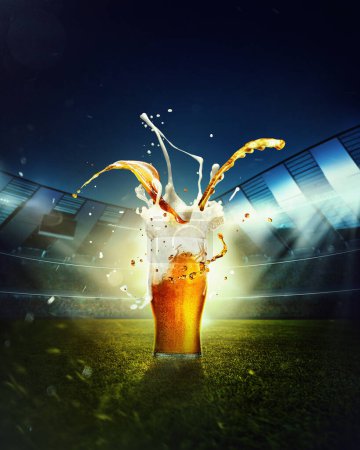 Photo for Beer and foam splashes. Mug with lager beer standing on grass at football stadium over evening sky with flashlights. Concept of sport, festival, competition, alcohol drinks, match. Copy space for ad. - Royalty Free Image