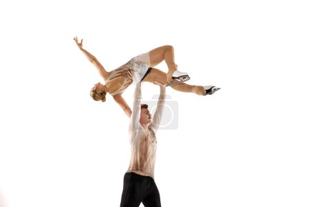 Photo for Young man and woman, figure skating athletes performing isolated over white studio background. Aesthetics of movements. Concept of movement, sport, beauty, hobby, competition, dance, choreography. Ad - Royalty Free Image