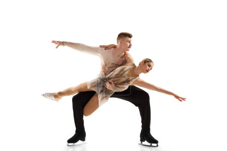 Photo for Sport show. Portrait of young man and woman, figure skating athletes performing isolated over white studio background. Concept of movement, sport, beauty, hobby, competition, dance, choreography. Ad - Royalty Free Image