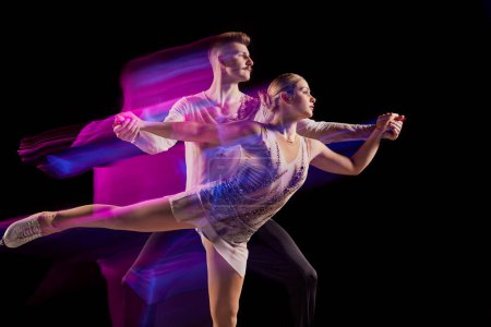Photo for Portrait of young man and woman, figure skating athletes dancing isolated on black background in neon with mixed lights. Concept of movement, sport, beauty, hobby, competition, dance, choreography. Ad - Royalty Free Image