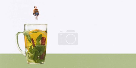 Photo for Contemporary art. Creative design. Young woman jumping into cup with mint tea with lemons and cinnamon. Tasty vitamin drink. Concept of hot drinks, coziness, taste, emotions, lifestyle. Poster, ad - Royalty Free Image