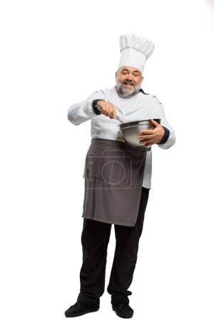 Photo for Portrait of bearded man, restaurant chef in uniform with bowl isolated on white background. Cooking. Concept of profession, occupation, hobby, food, lifestyle, taste. Ad - Royalty Free Image