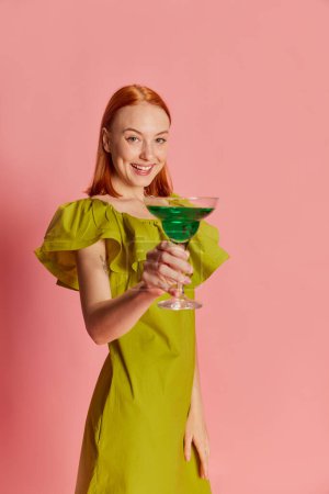 Photo for Portrait of young beautiful girl in cute dress posing with cocktail over pink background. Party mood, celebration. Concept of youth, beauty, fashion, lifestyle, emotions, facial expression. Ad - Royalty Free Image