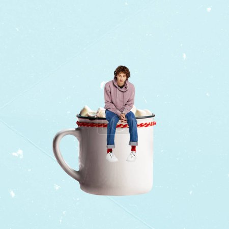 Téléchargez les photos : Contemporary art collage. Creative design. Young sad man sitting on cup with cocoa or hot chocolate with marshmallow. Concept of hot drinks, coziness, taste, emotions, lifestyle. Poster, ad - en image libre de droit