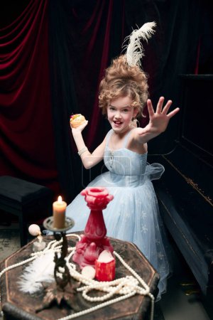 Photo for Portrait of little girl, child in image of medieval royal person playing with cake. Delicious food. Concept of historical remake, comparison of eras, medieval fashion, emotions, childhood - Royalty Free Image